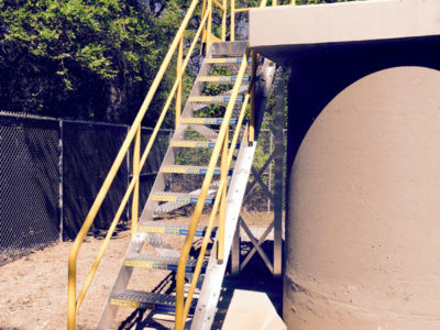 Erectastep Staircase secured to work tower with slip-resistant safety tread and handrails