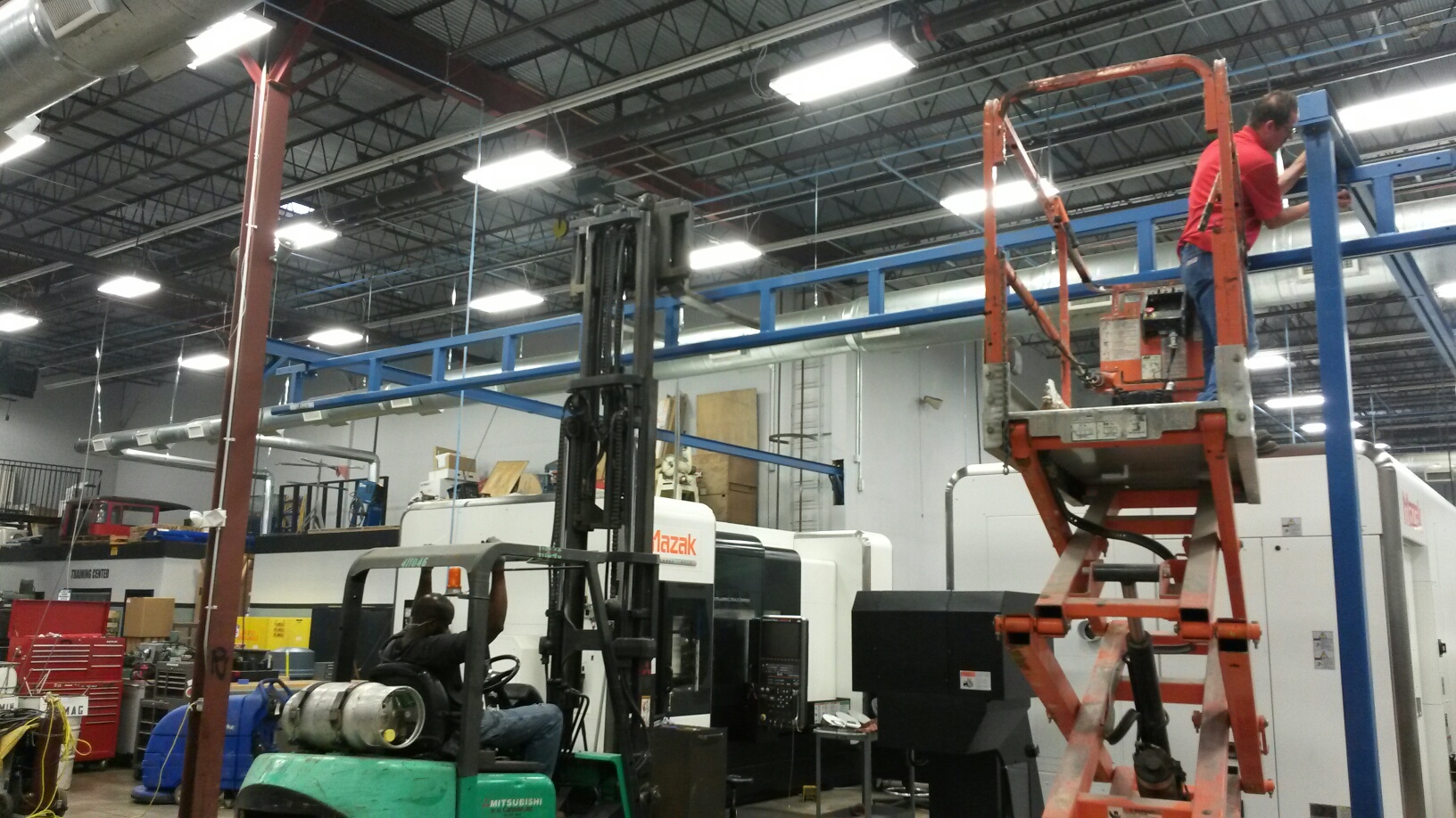 Gorbel Workstation and Jib Crane System Designed for Loading and Unloading Heavy Equipment for the Energy Industry in a CNC Machine Shop in Dallas, TX